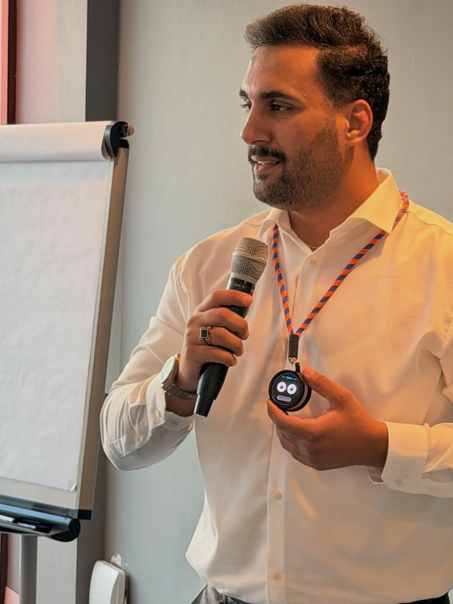 Saman, CEO of SK Prime, presenting Tichi to an audience while holding the Pocket Tichi prototype on a lanyard